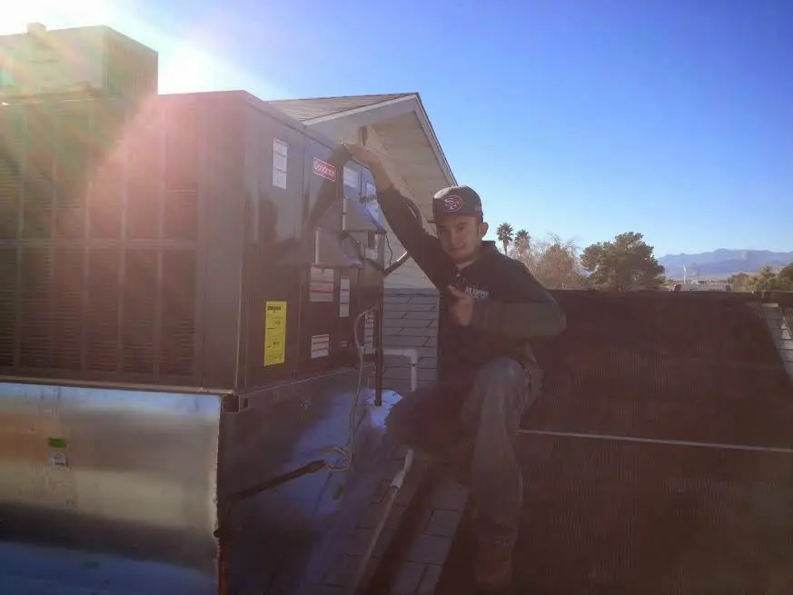 HVAC technician performing Boiler Repair on a rooftop unit in Brookfield